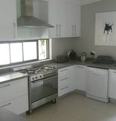 High gloss white Kitchen with Concrete grey worktops