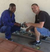 Jerry and Cornel working on a garage door