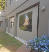 Outdoor roller blind, enclosing patio to keep in warmth