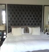 Custom made buttoned headboard with mirrors and curtaining