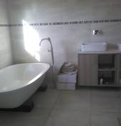newly renovated bathroom with a vanity & ceasarstone top