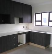 kitchen built in cupboards in burnt oak colour blended with a white caesarstone which is stain,scratch,fading,water & bacteria resistant
