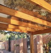 End result photo. Here our handyman team installed a Pergola structure to create a covered patio with a see through roofing.