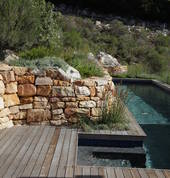 Rock walls built on the edge of the mountain to allow this stunning lap pool to be built surrounded by fynbos
