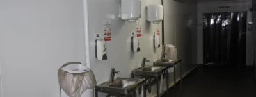 Basins with thermo faucets at entrance to food process plant