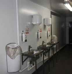 Basins with thermo faucets at entrance to food process plant