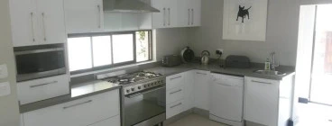 High gloss white Kitchen with Concrete grey worktops