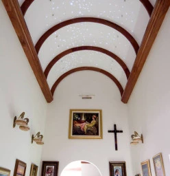 barrel arched ceiling with southern cross lights in ceiling over the art gallery leading to the bedrroms