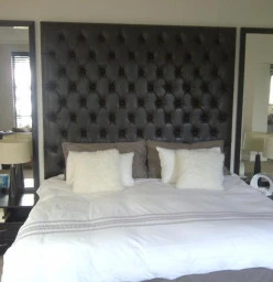Custom made buttoned headboard with mirrors and curtaining