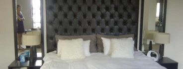 Custom made buttoned headboard with mirrors and curtaining