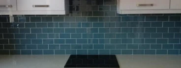 Glass mosaic installation. Our clients out in Blouberg strand were blown away at how beautiful their new kitchen backsplash turned out. With the white grout, the mosaics really put that pop of colour