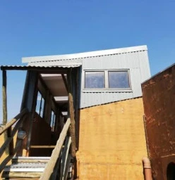 2nd storey balcony converted to office with new roof and cladding.