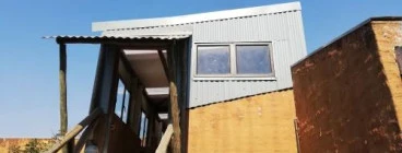2nd storey balcony converted to office with new roof and cladding.