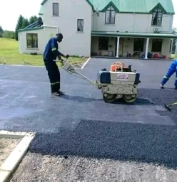 Indlu Yegagu Iyanetha laying tar driveway and road